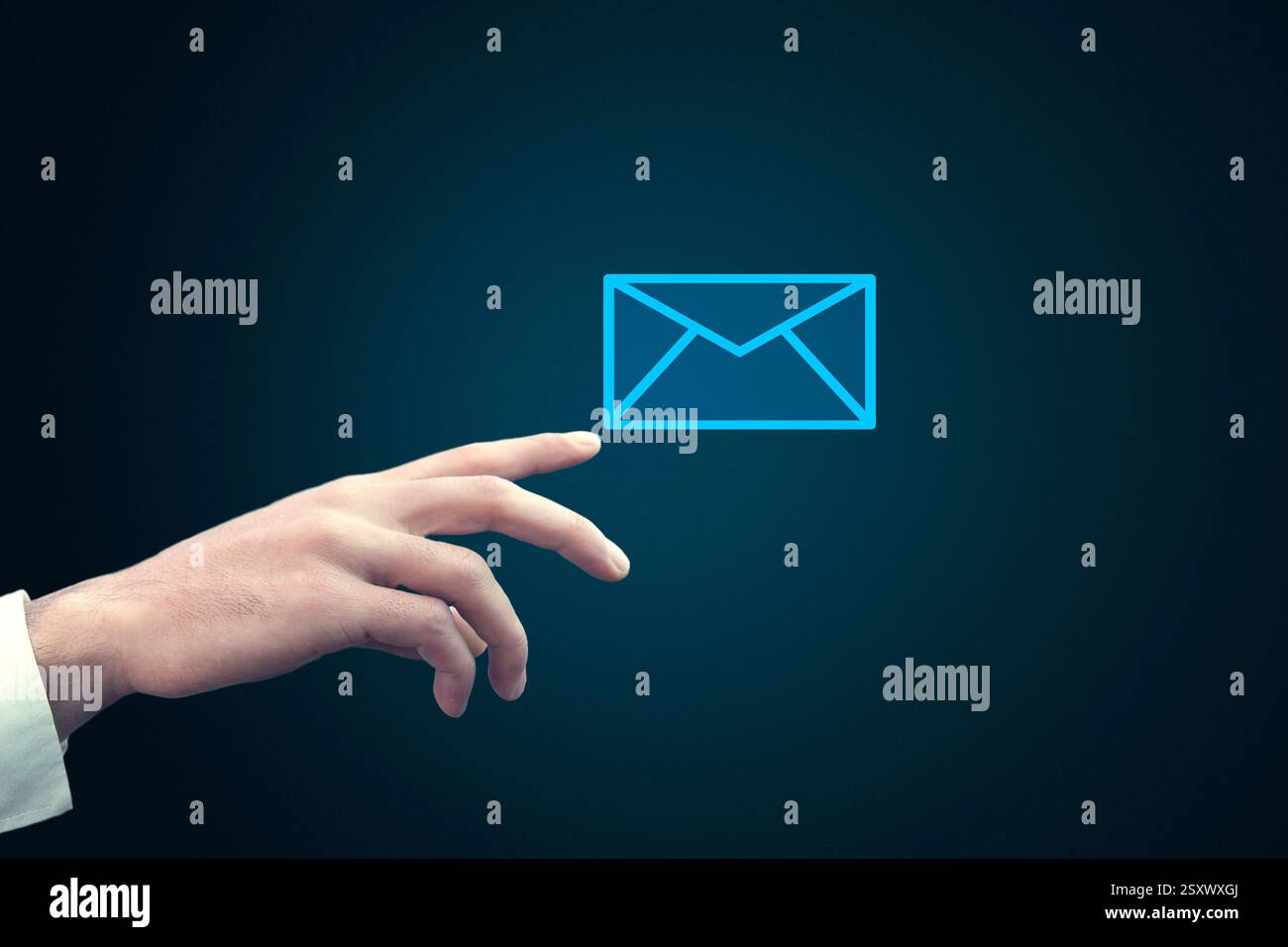 Businessman touching email icon on a virtual screen Stock Photo