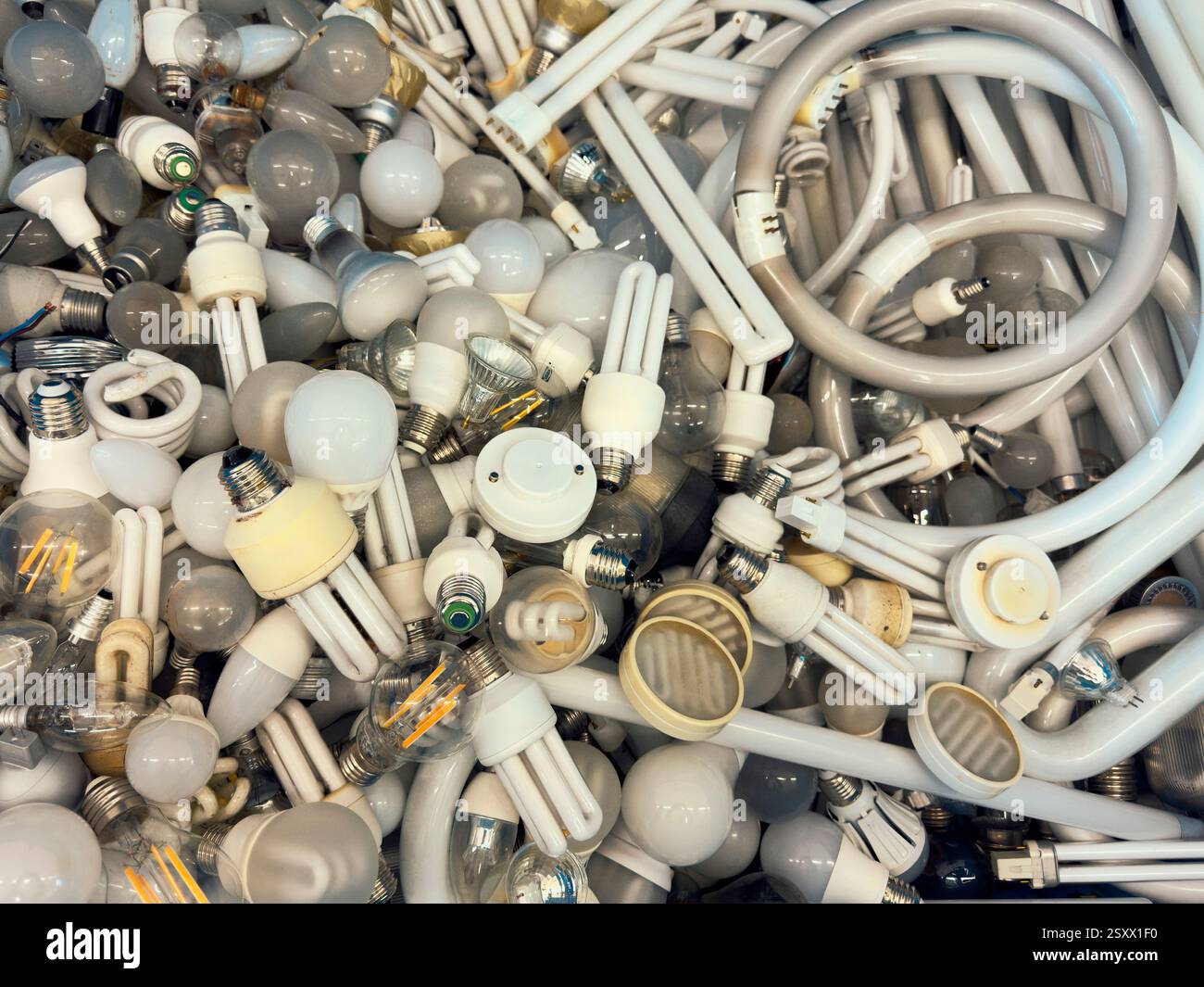 View from above heap of various discarded fluorescent light bulbs Stock Photo