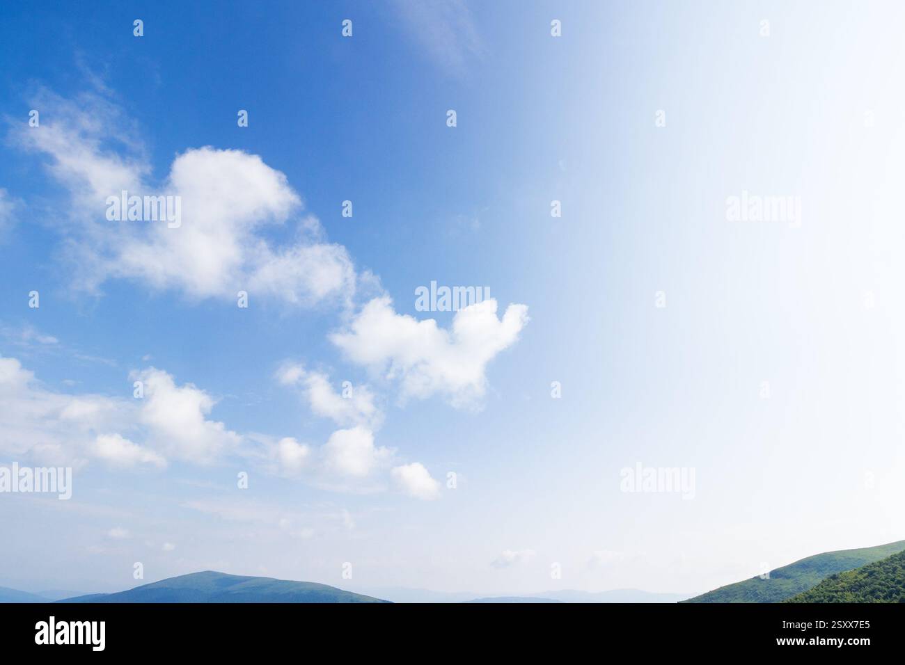 white cumulus clouds on a blue sky. wonderful nature background of atmosphere condition in day light. bright summer weather forecast. fresh air Stock Photo
