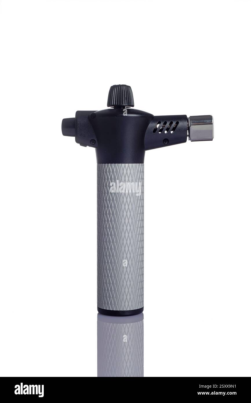 a handheld butane torch for kitchen use on a white background Stock Photo