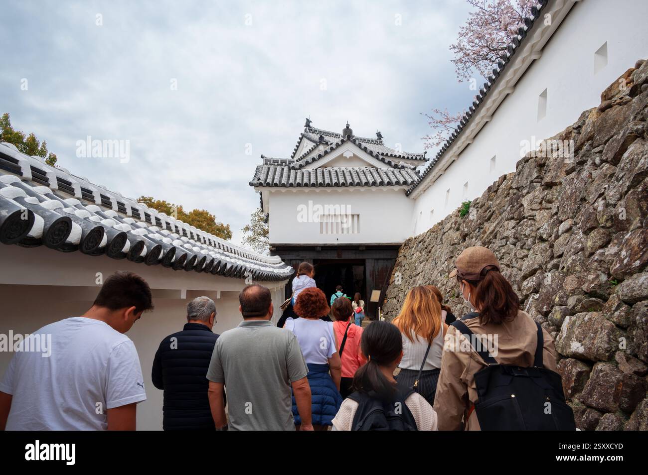 Tourists inside the Himeji Castle, a hilltop Japanese castle complex ...