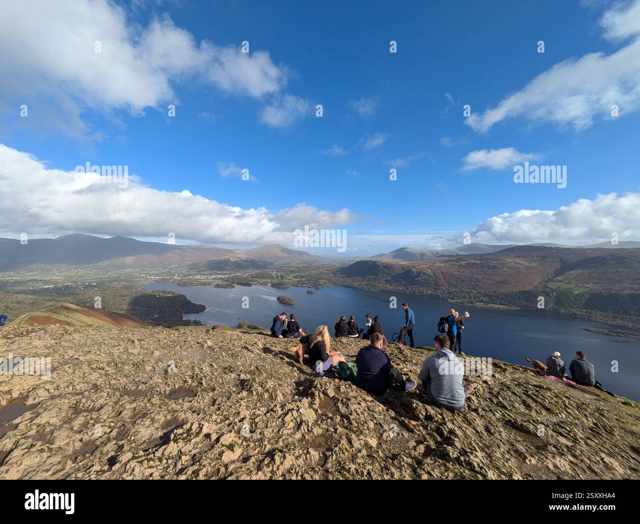 Visitors enjoy the view over Derwent Water from the summit of Cat bells, The Lake District, UK - Smartphone Captured Stock Image