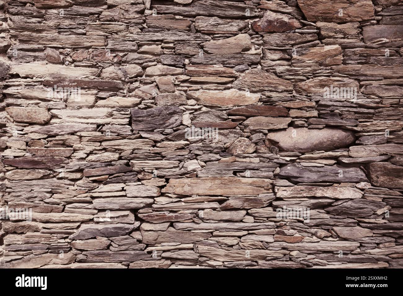 Retro stone wall texture. Natural stone wall background. Stock Photo