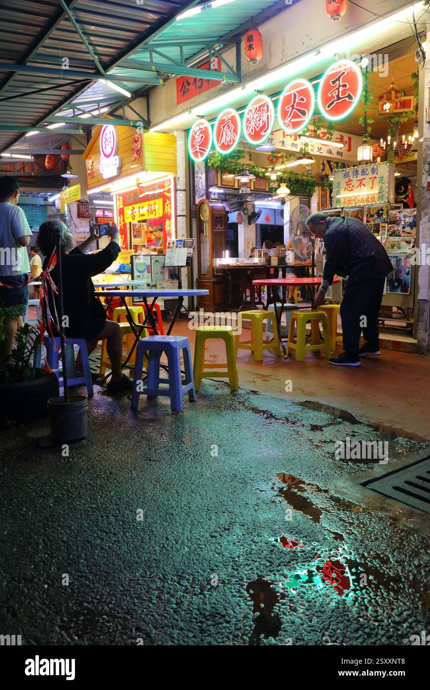 KUALA LUMPUR, MALAYSIA - MARCH 17, 2024: People visit Restoran Ruby restaurant on a rainy night in downtown Kuala Lumpur city. Stock Photo