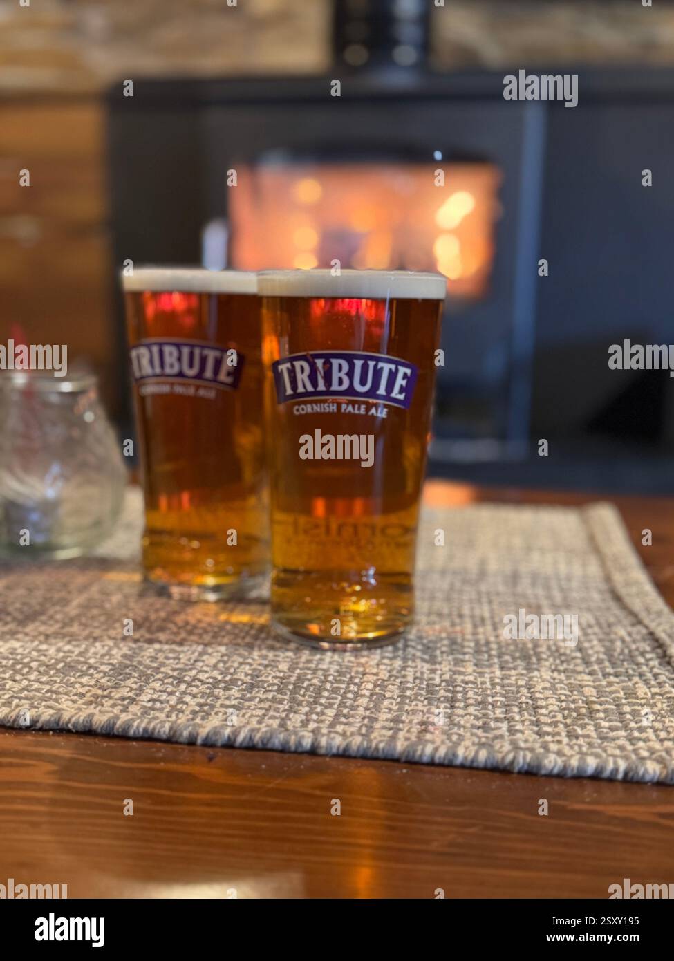 two pints of tribute in a lovely pub in Cornwall. In front of a log burner - Smartphone Captured Stock Image