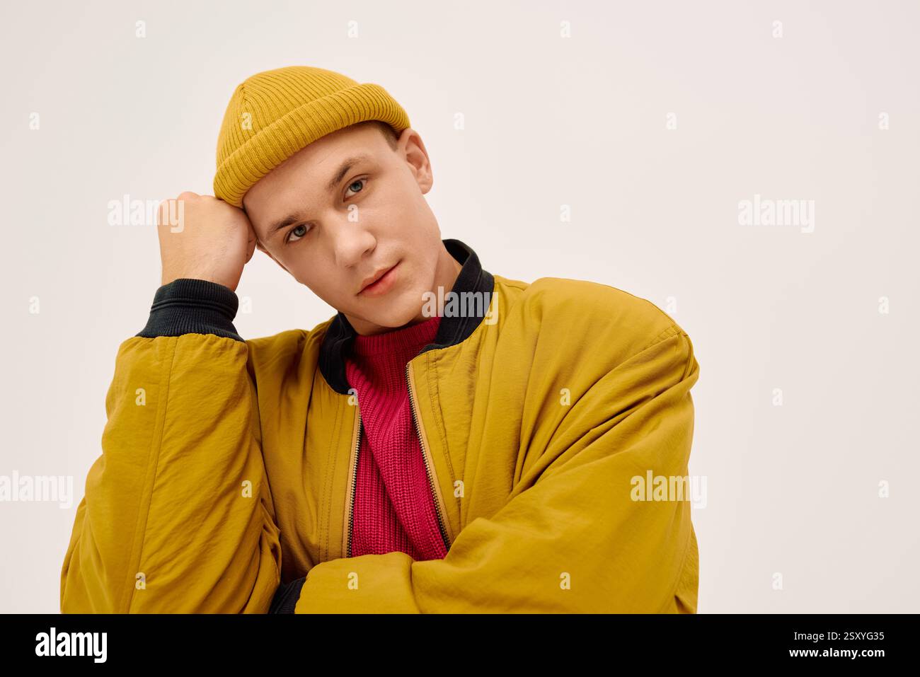 A stylish young man poses confidently in fashionable attire within a ...
