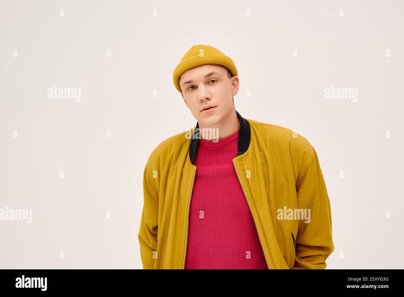 A handsome young man poses confidently, sporting fashionable attire in ...