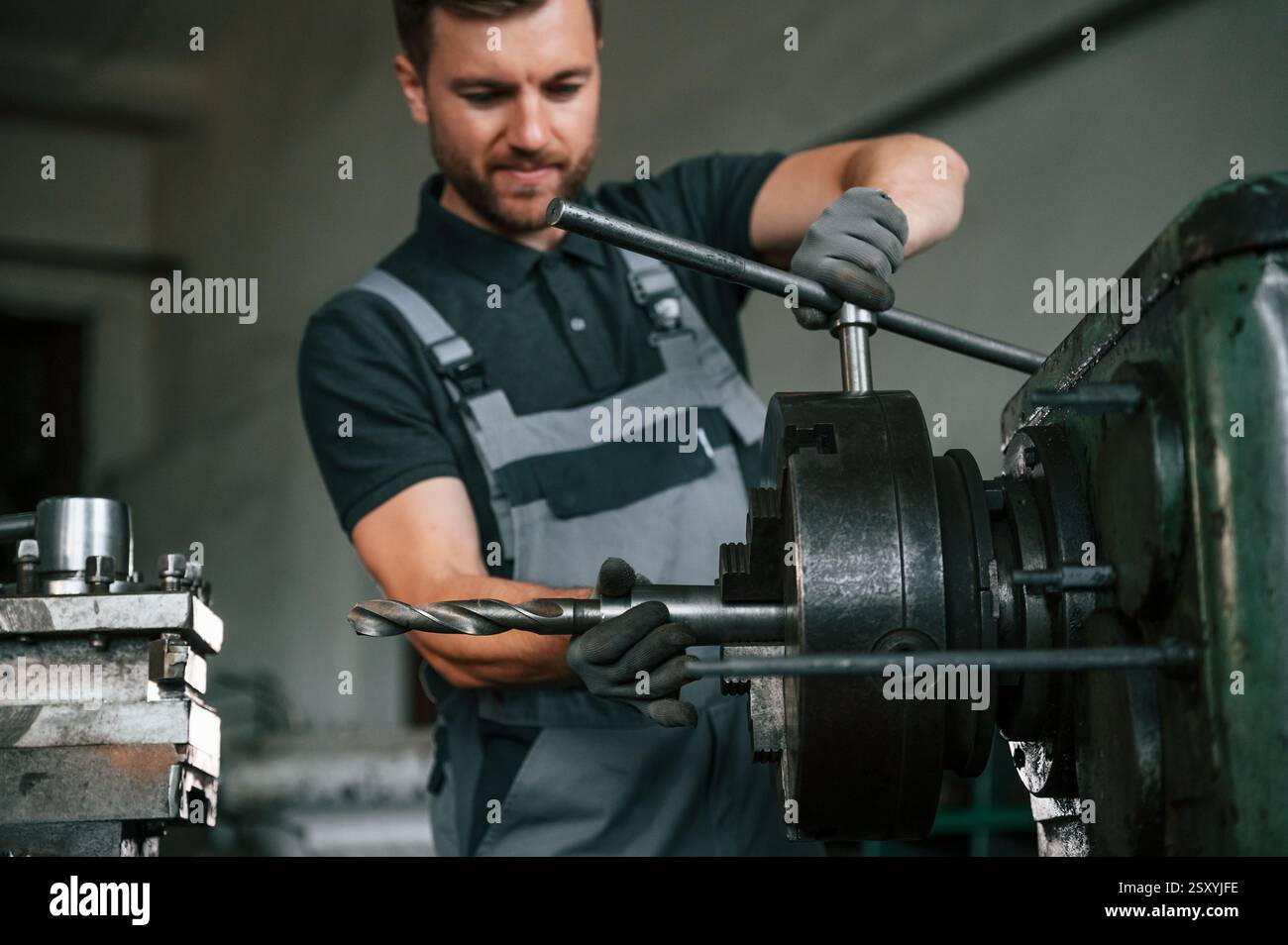 Crafting details. Man in uniform is in workstation developing details ...