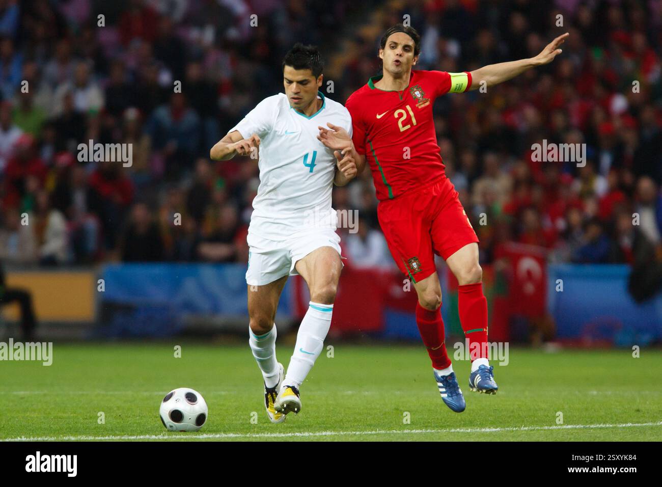 Portugal team captain Nuno Gomes (21) defends against Gokhan Zan of Turkey (4) during a UEFA Euro 2008 Group A match between Portugal and Turkey on June 7, 2008 at the Stade de Genève in Geneva, Switzerland. Editorial use only. Commercial use prohibited. (Photograph by Jonathan Paul Larsen / Diadem Images) Stock Photo