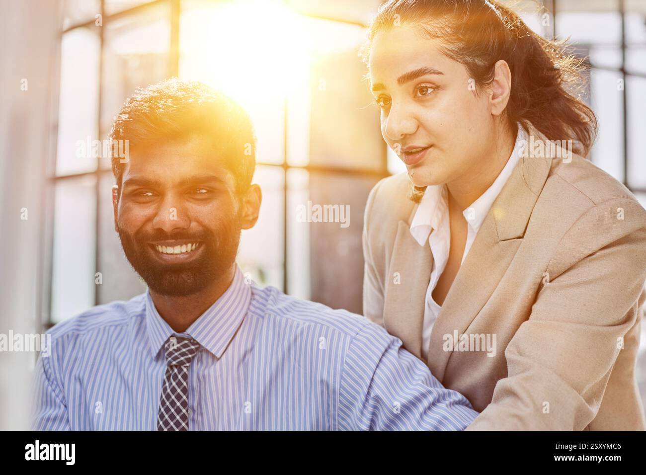 Working together on project. Two young business colleagues working on computer Stock Photo