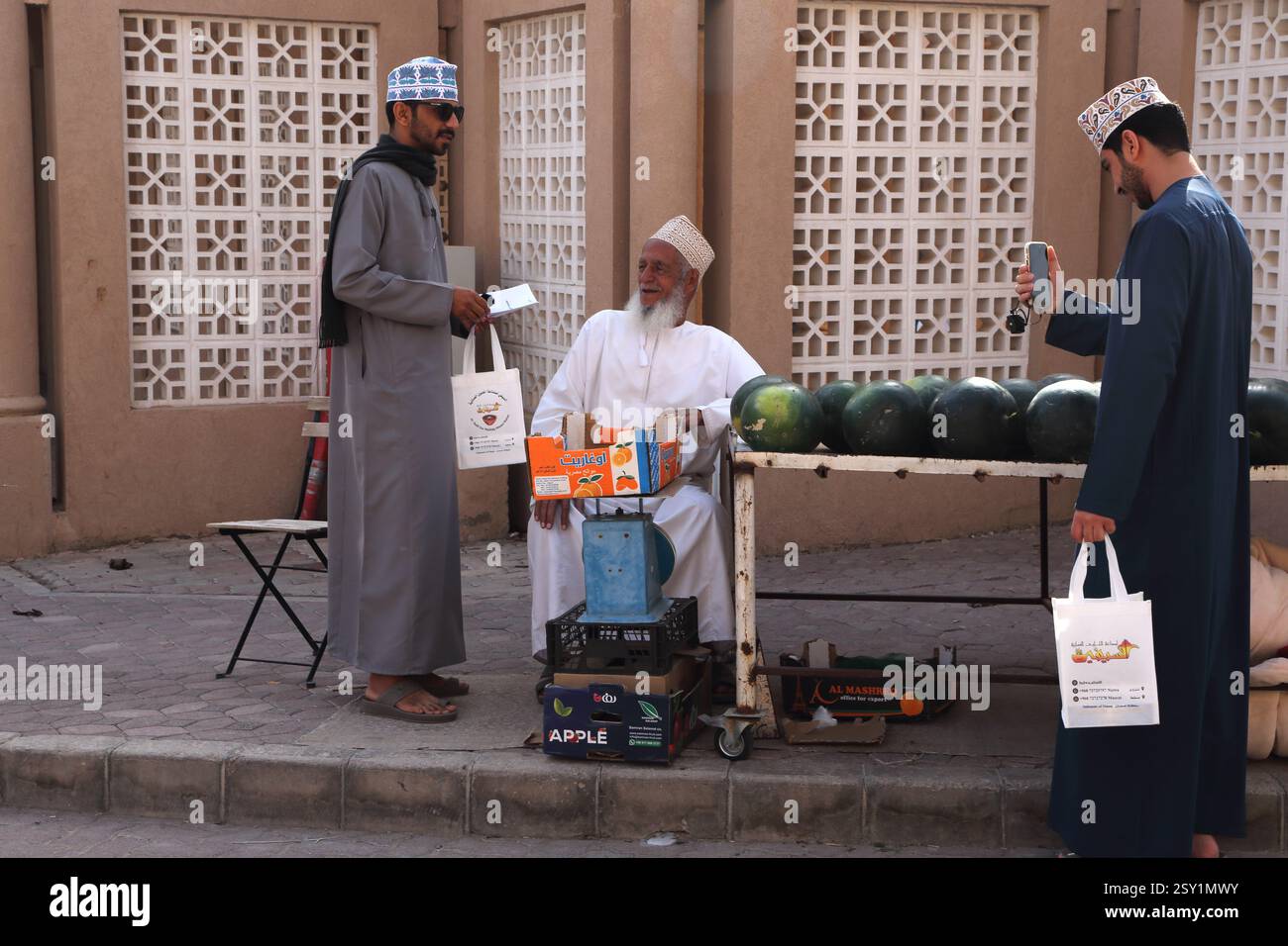 Omani Man using Mini GoPro Camera attached to his Mobile Phone Taking ...