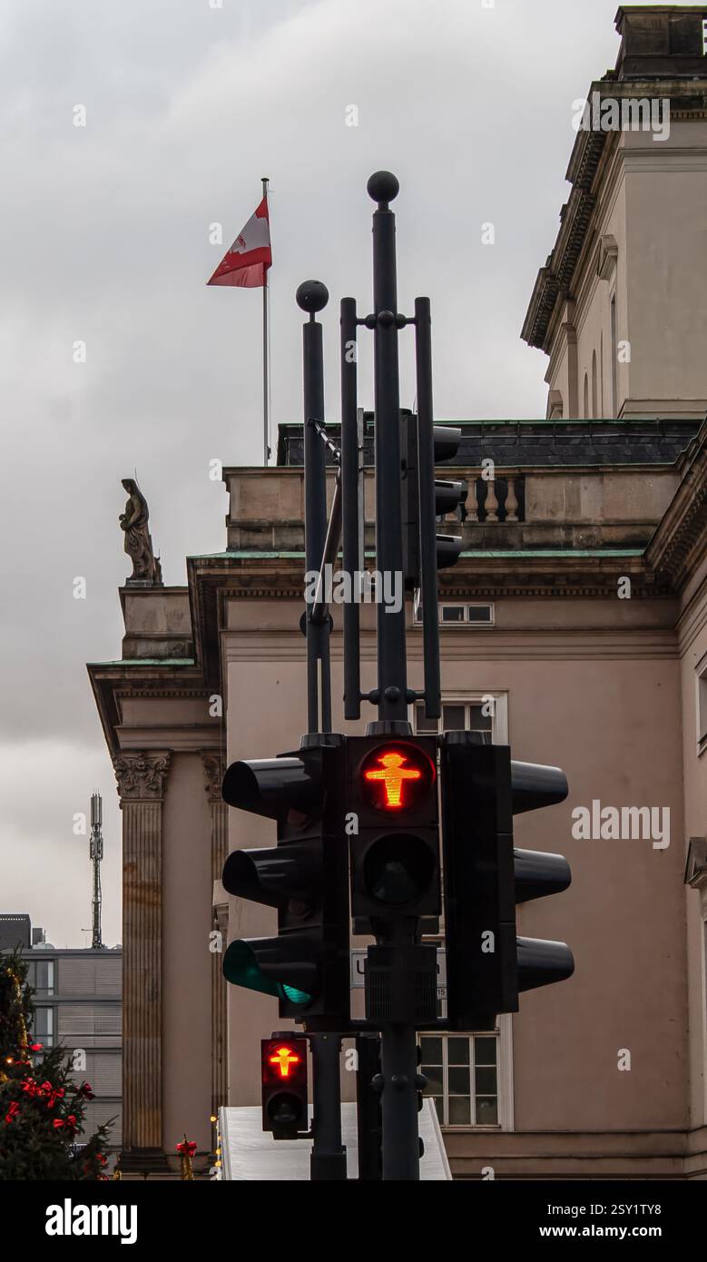 Red traffic light showing standing man in berlin Stock Photo - Alamy