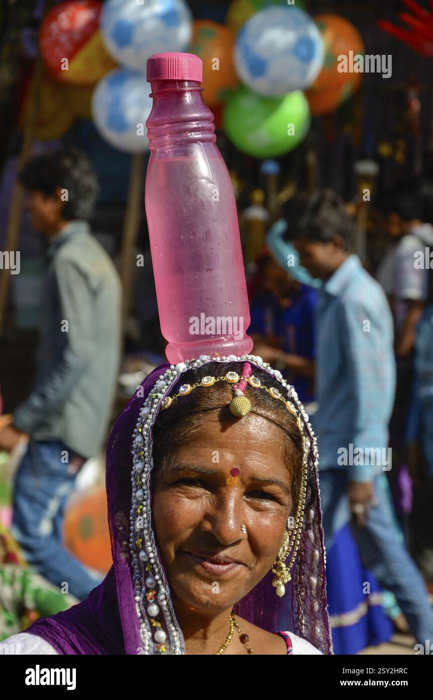 Woman holding water bottle on head,