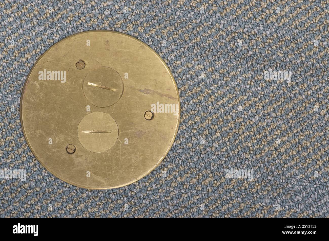 Brass plate on a carpeted floor Stock Photo