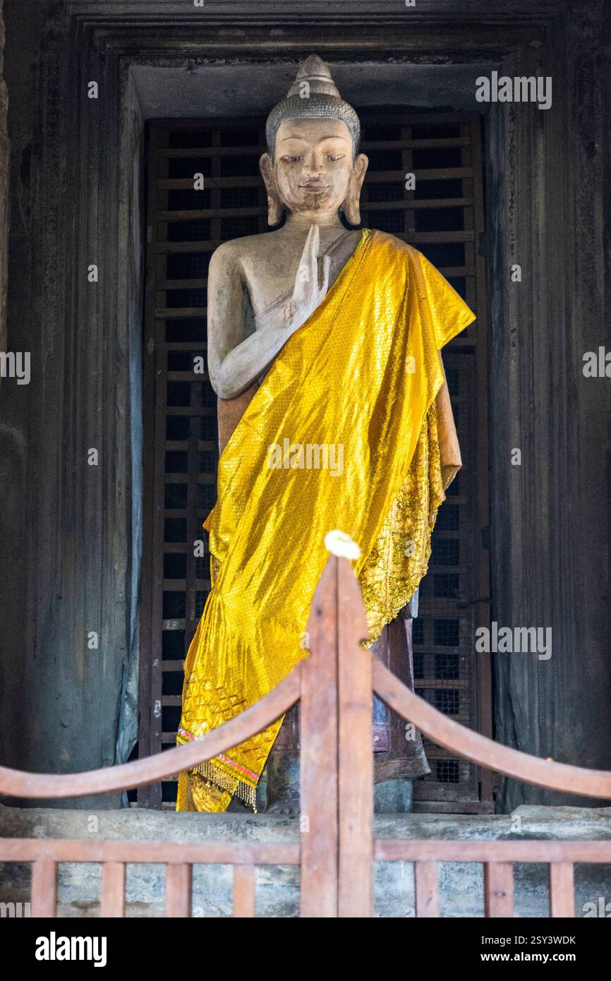 Statue of Buddha adorned with golden robe at Angkor Wat, the world’s ...