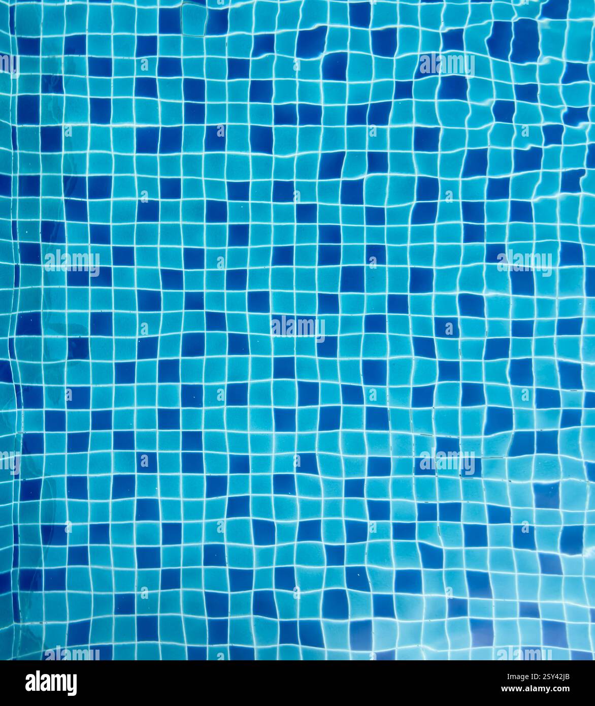 Colorful tile patterns of a swimming pool under sunlight creating ...
