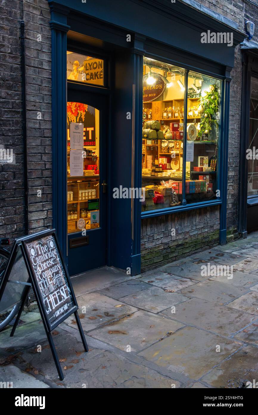 Cheese shop in Cambridge town centre in the early evening at Christmas. England, UK Stock Photo