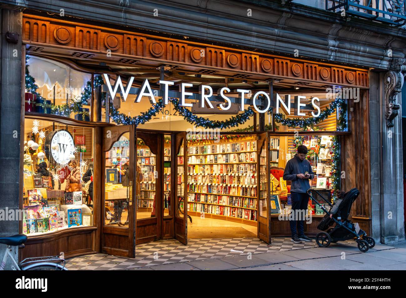 Shoppers in Cambridge town centre in the early evening at Christmas. England, UK Stock Photo