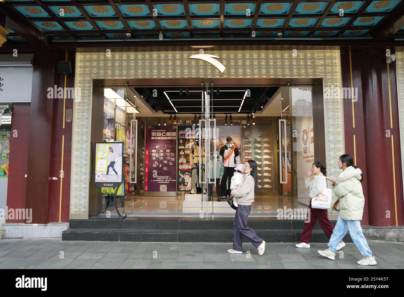 Shanghai, China. 27th Feb, 2025. Tourists walk past the flagship store of Anta in Shanghai, China, February 27, 2025. (Photo by CFoto/Sipa USA) Credit: Sipa US/Alamy Live News Stock Photo