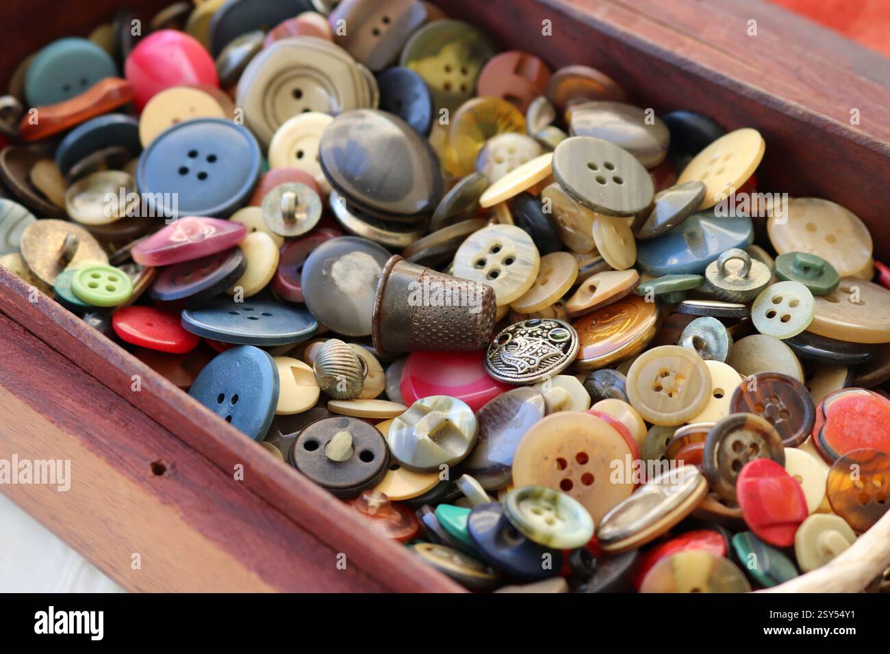 many old buttons are in a box Stock Photo