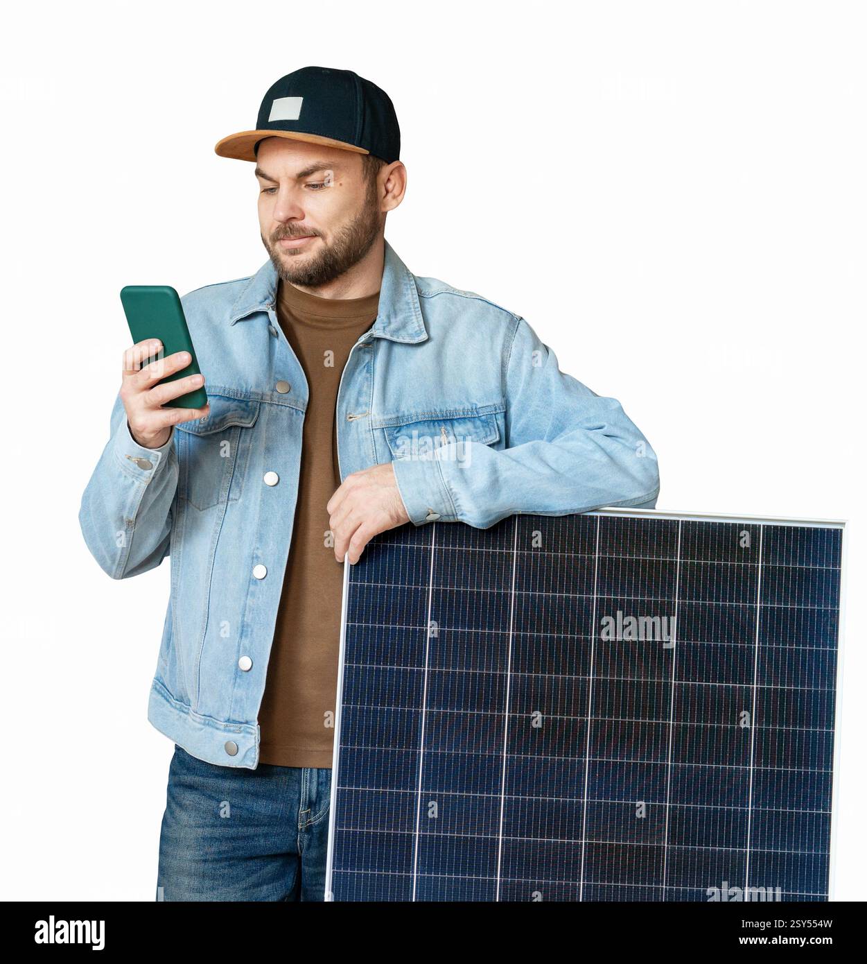 Cutout modern man standing next to solar panel and using his smart phone Stock Photo