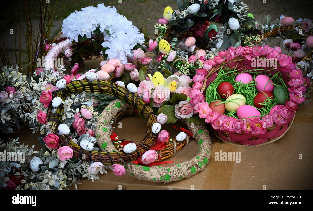 Decorative Easter garlands with flowers and painted eggs Stock Photo