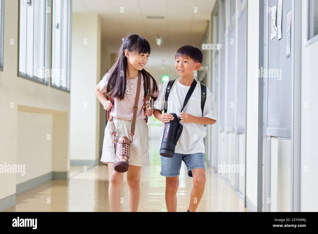 Japanese Kids Walking Down A School Hallway Stock Photo
