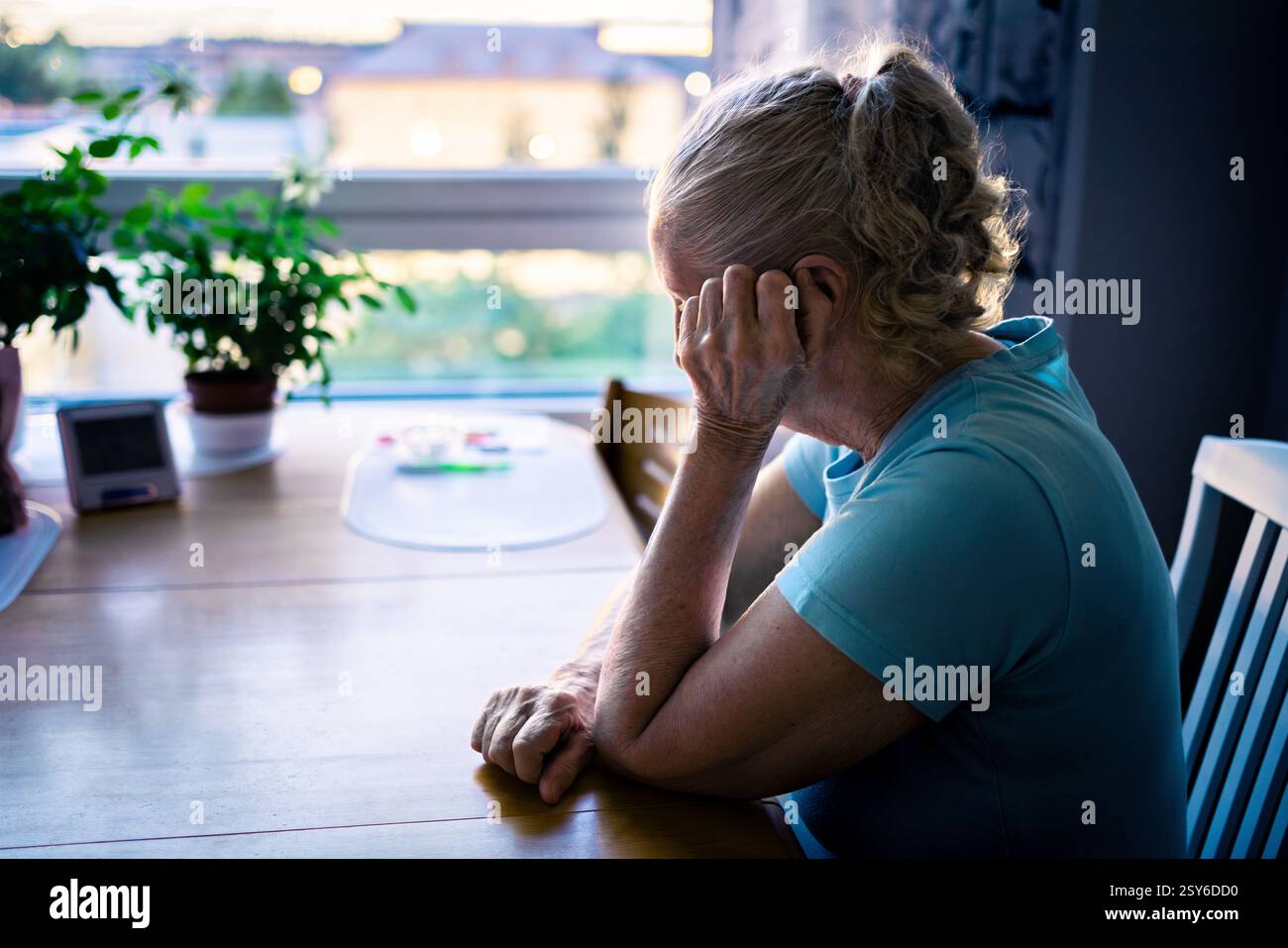 Loneliness of old senior woman with dementia, anxiety or alzheimer. Sad depressed elder lady crying. Memory loss, stress or trauma. Lonely sick person. Stock Photo