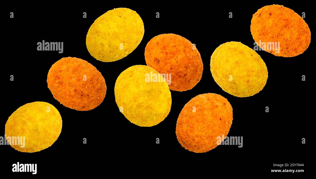 Falling coated peanuts isolated on black background Stock Photo