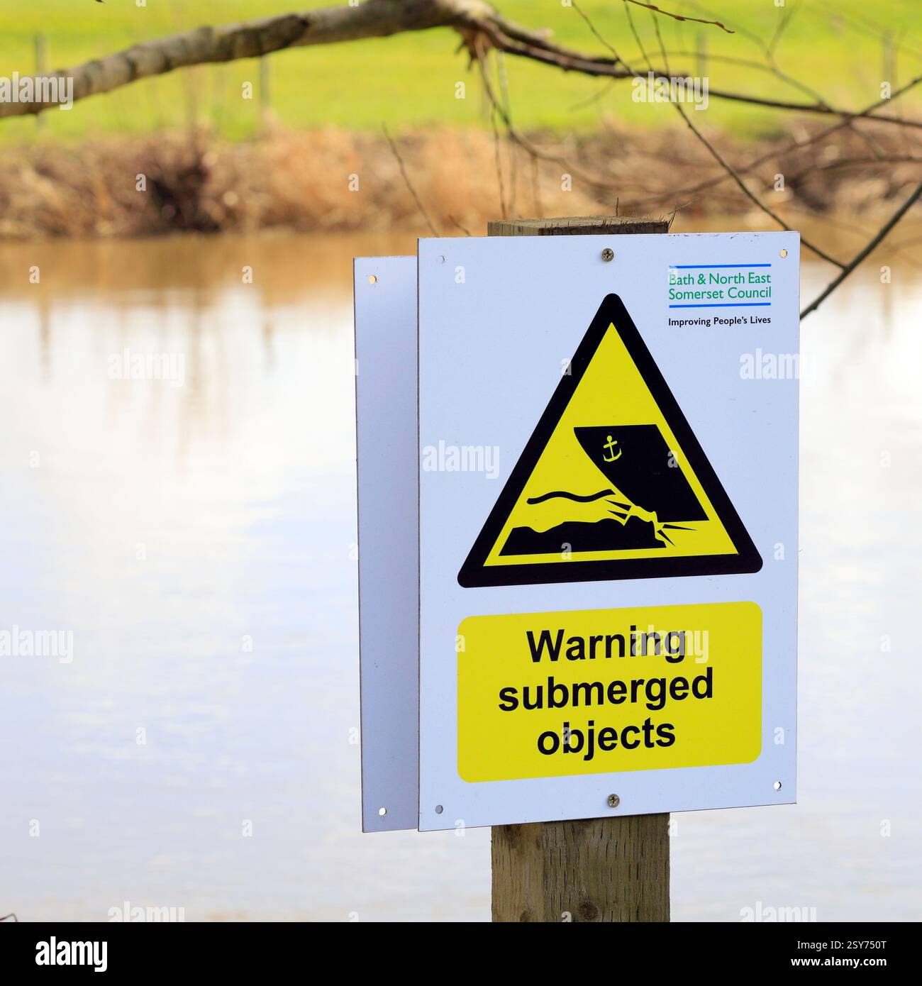 Warning, Submerged Objects sign on the banks of the river Avon, Mead ...