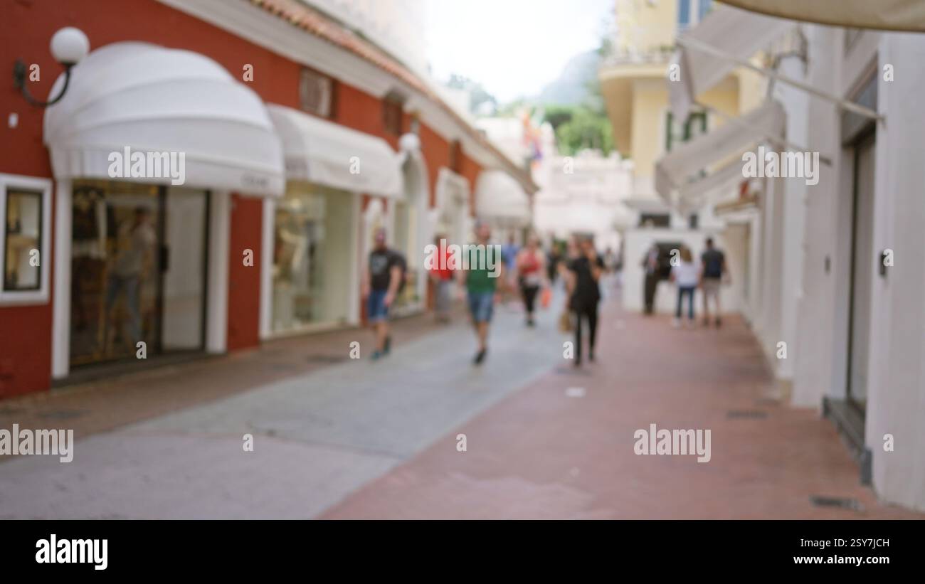 Blurred people walking along a luxury shopping street in capri, italy ...