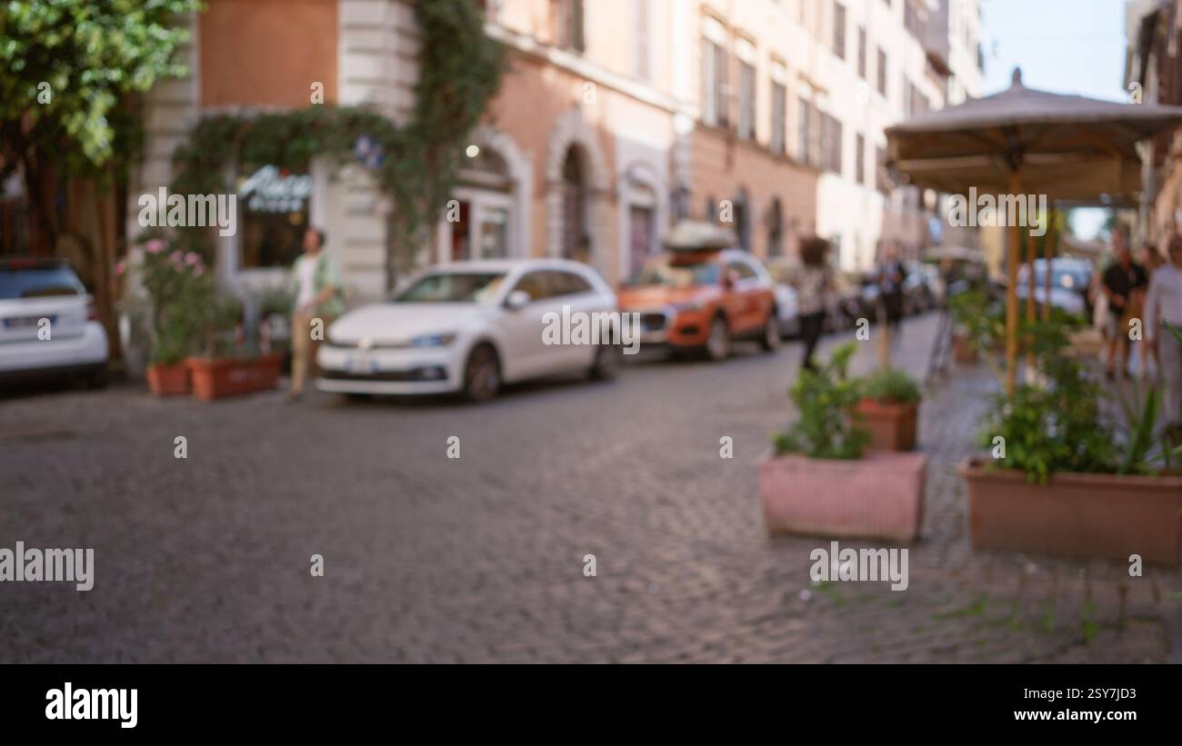 Blurred street scene in rome with cars and pedestrians against a ...