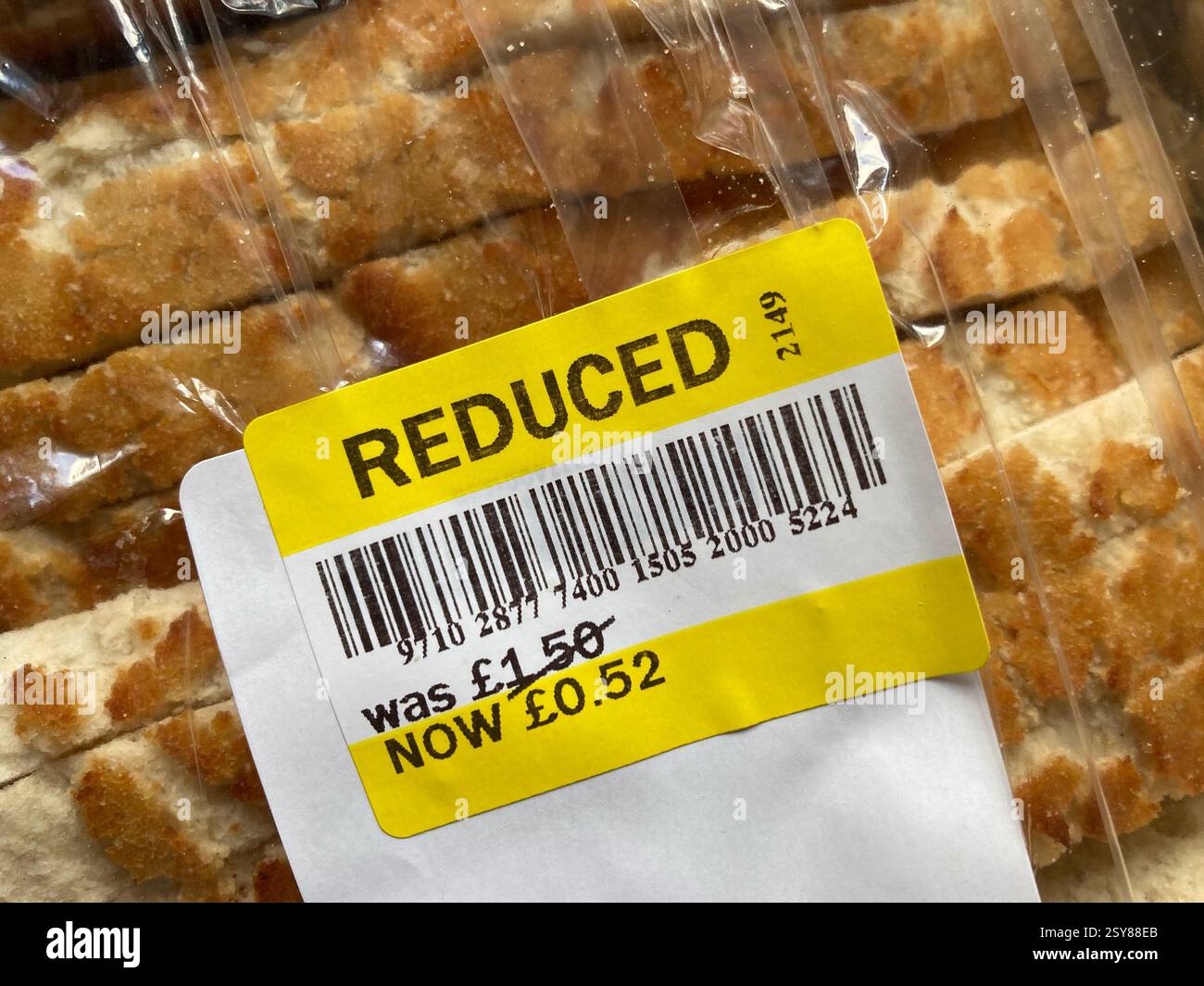 Reduced price supermarket sticker on a loaf of white sliced bread close up - Smartphone Captured Stock Image