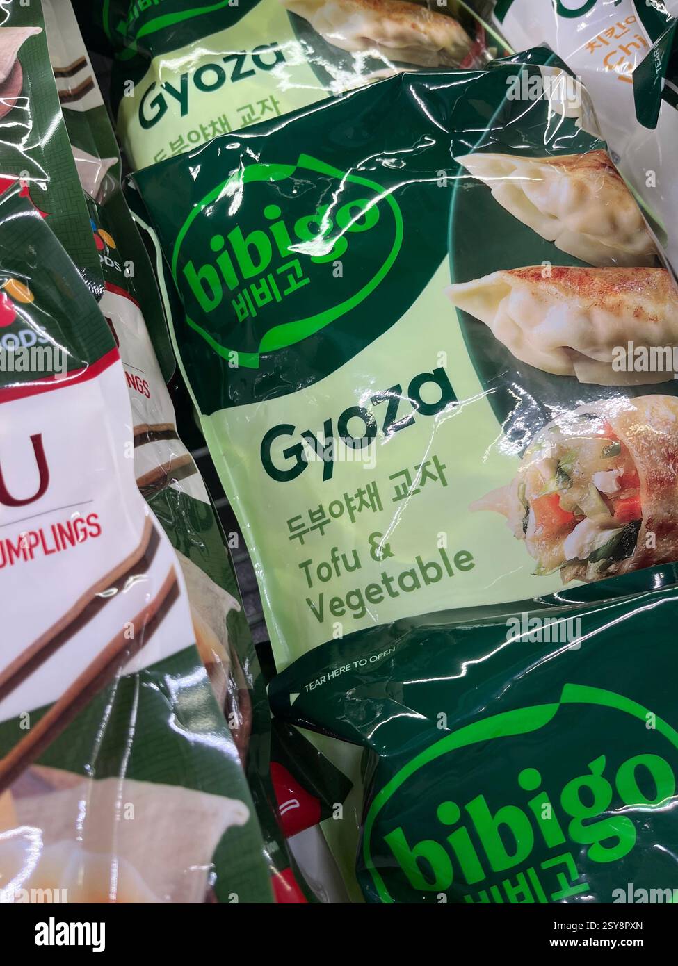 Frozen Gyoza tofu and vegetable dumplings, packaged and stored in  supermarket freezer section, Asian food, produced by Bibigo - Smartphone Captured Stock Image