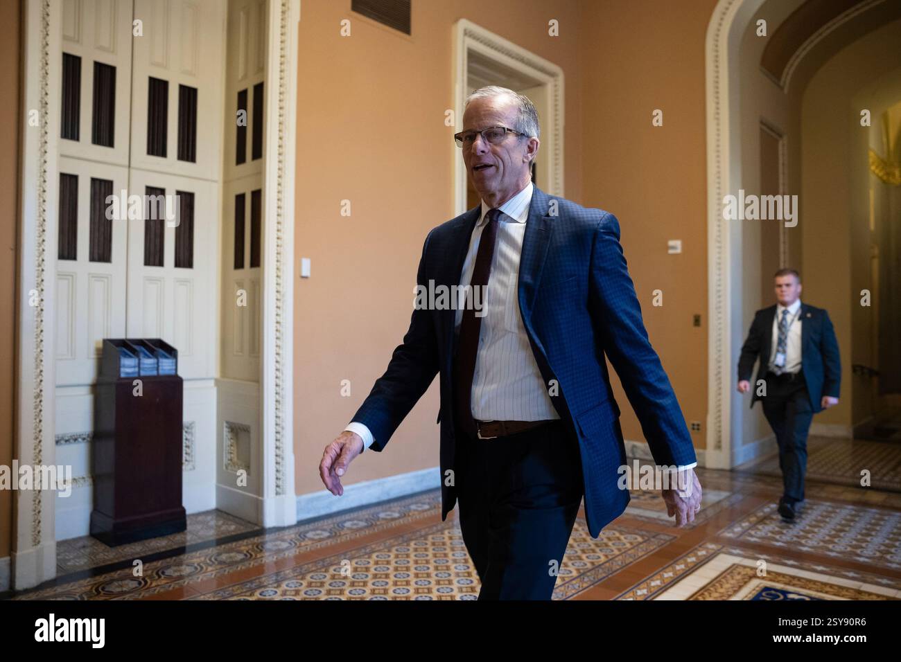 Senate Majority Leader John Thune (R-S.D.) walks to the Senate chamber ...