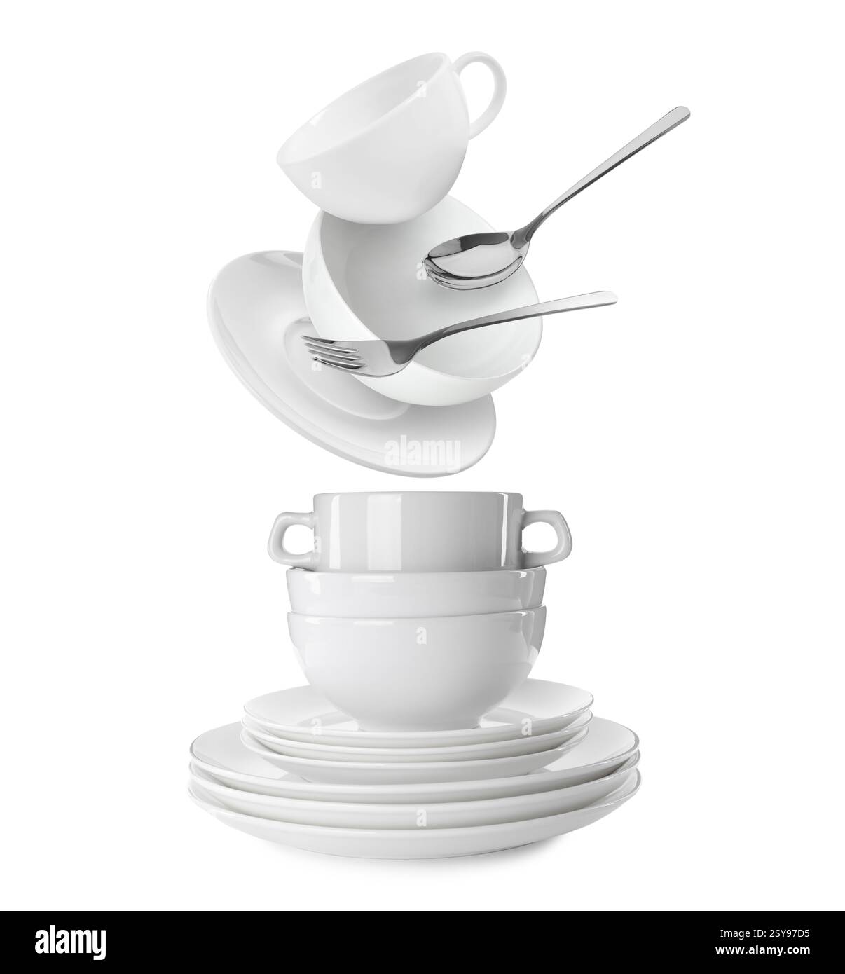 Clean dishware and silverware flying over tableware on white background Stock Photo