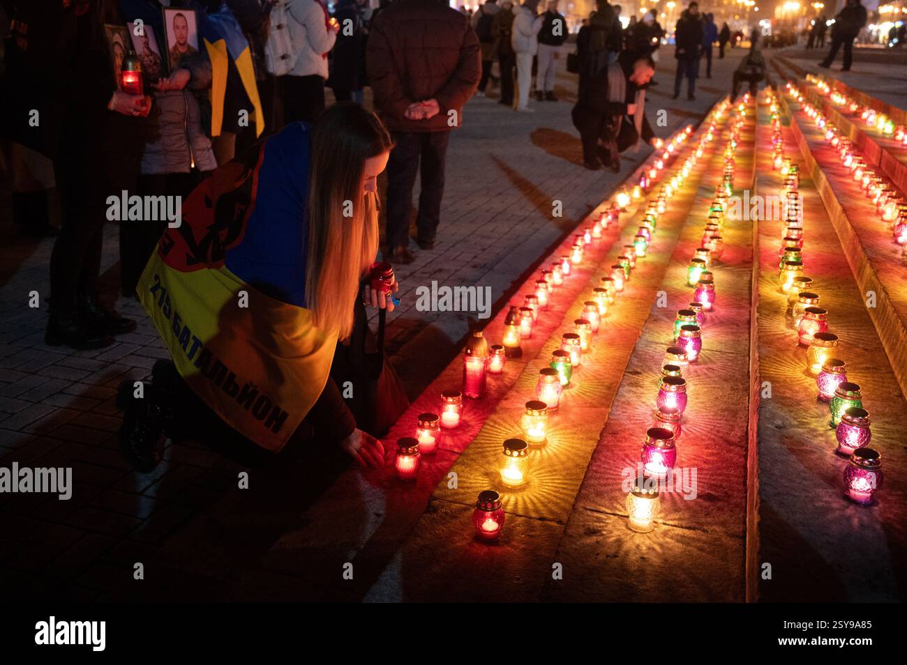 Non Exclusive: A woman puts a lit candle on the steps in Maidan ...