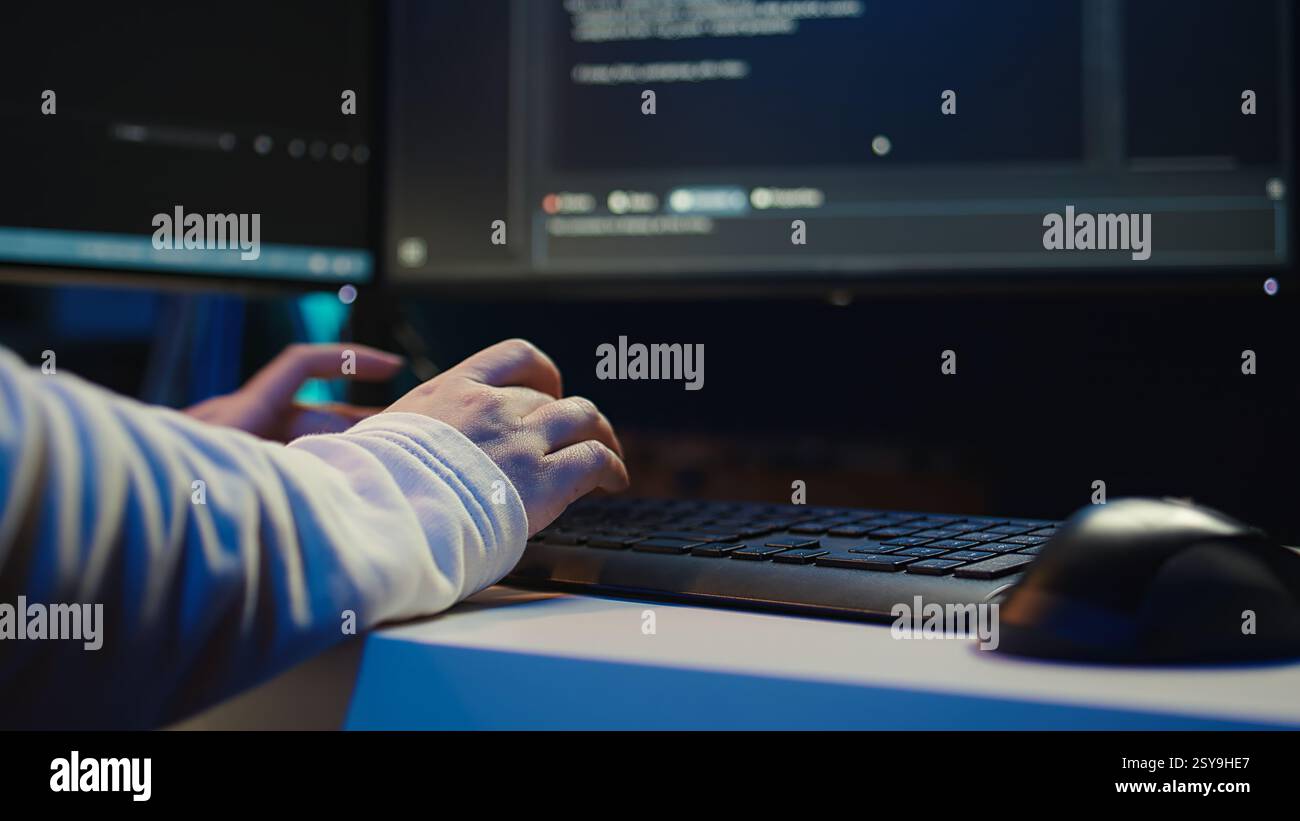 Technician doing software quality assurance, reading source code on PC before implementing it. IT admin inspecting coding on computer, looking to fix potential issues, camera B close up Stock Photo