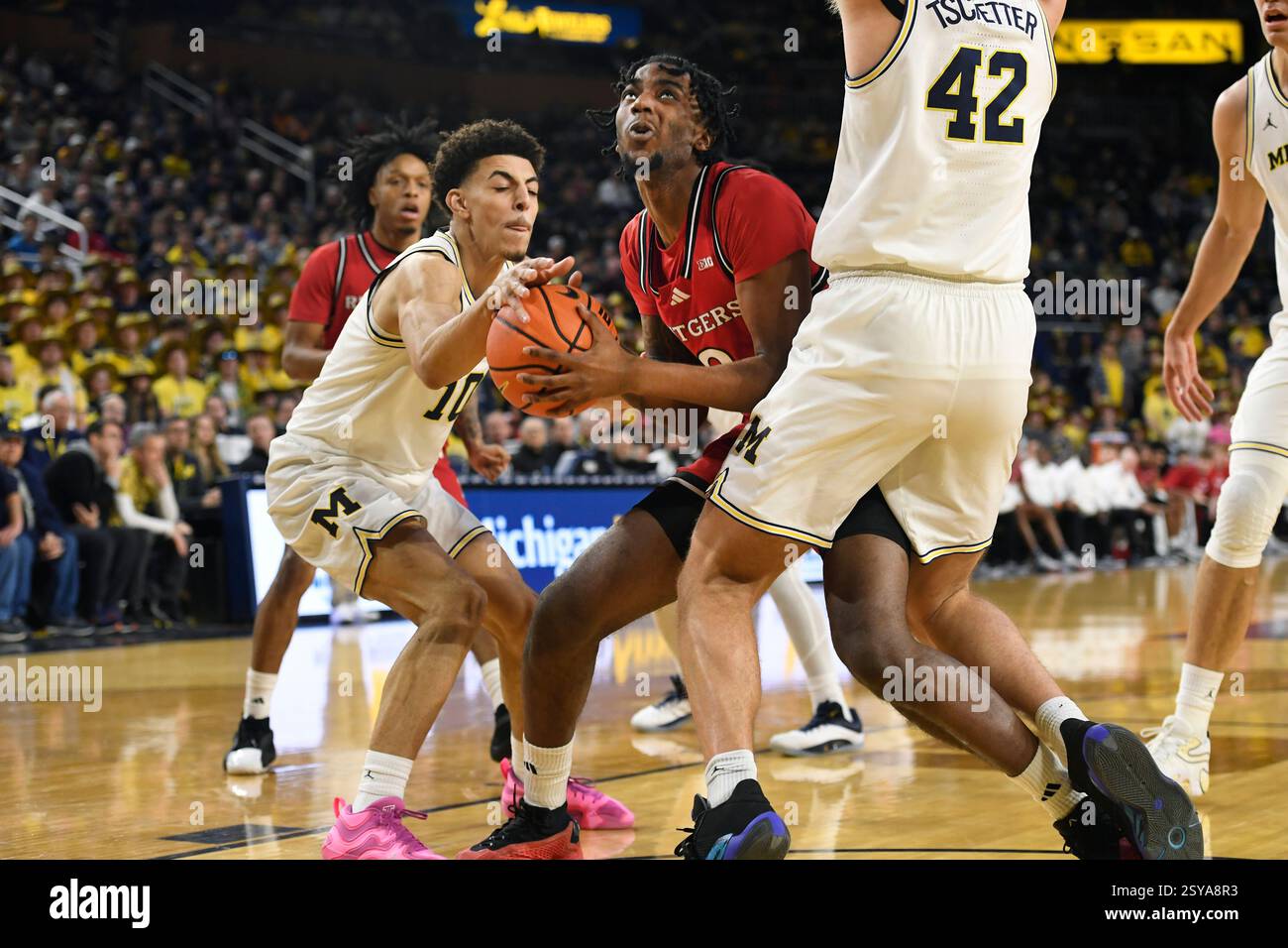 Rutgers forward Bryce Dortch, middle, tries to shoot in between ...