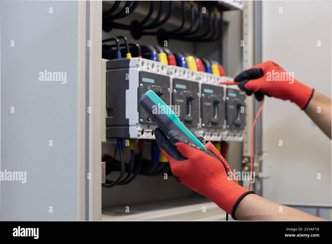 Electrical engineer checks the operation of the electrical control ...