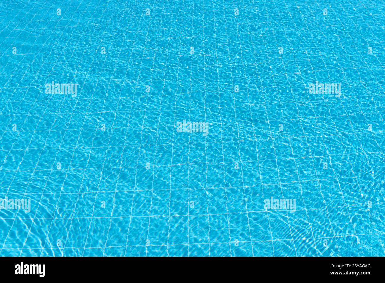 Ripple water in swimming pool with sun reflection. Background shot of ...