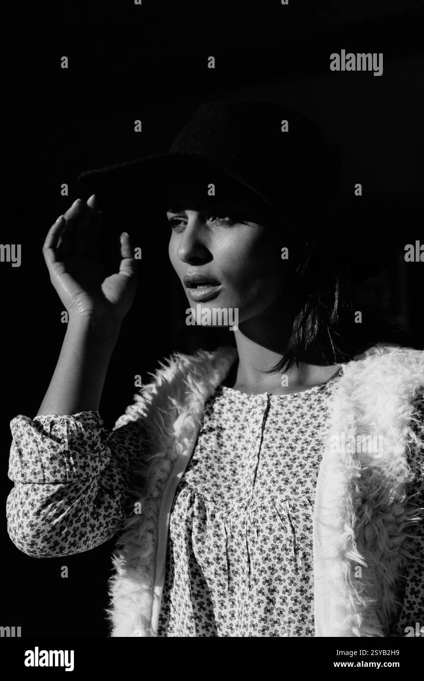 A striking black and white portrait of a woman wearing a hat and ...