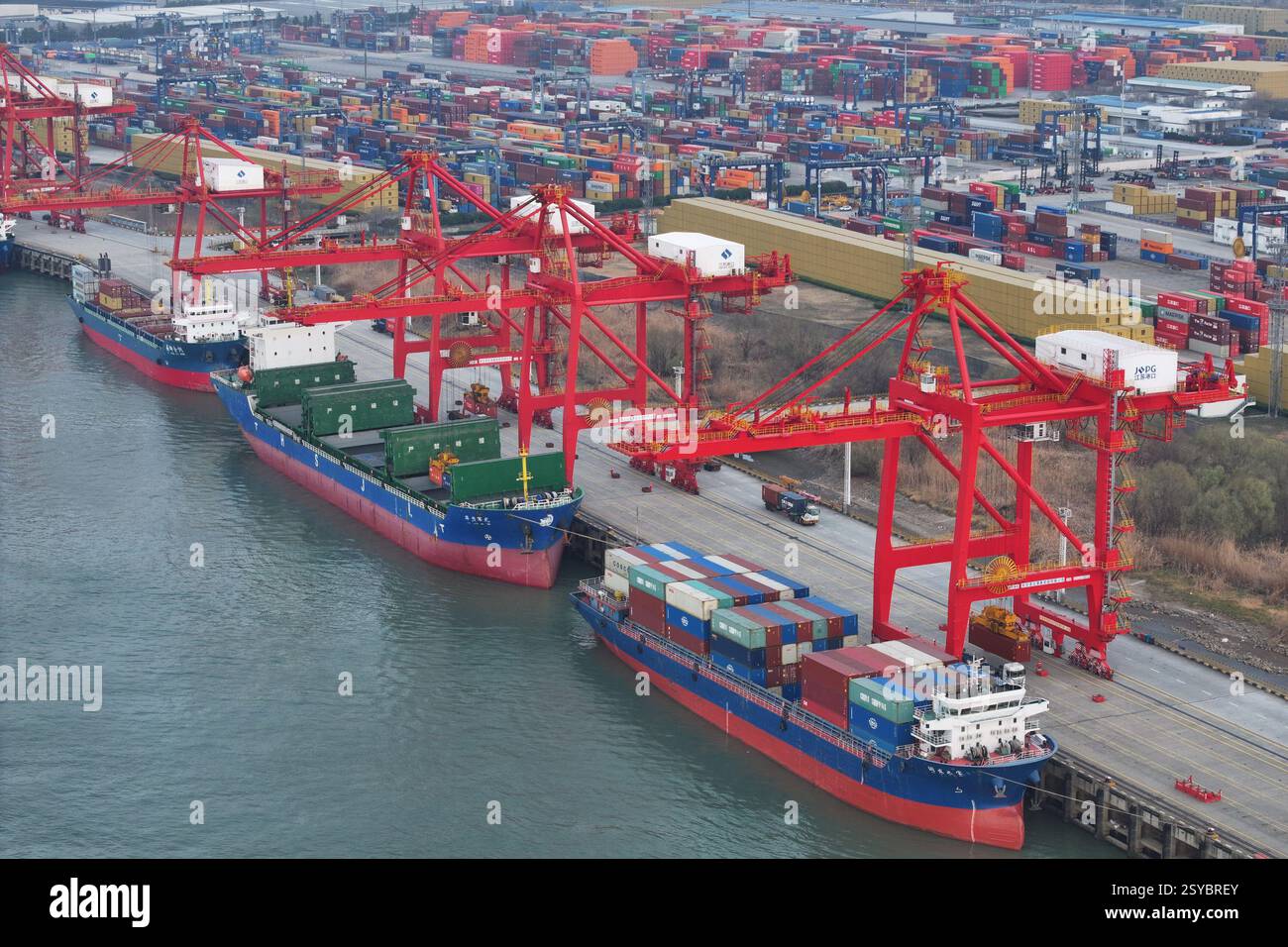 Cargo ships load and unload containers at the Longtan Container ...