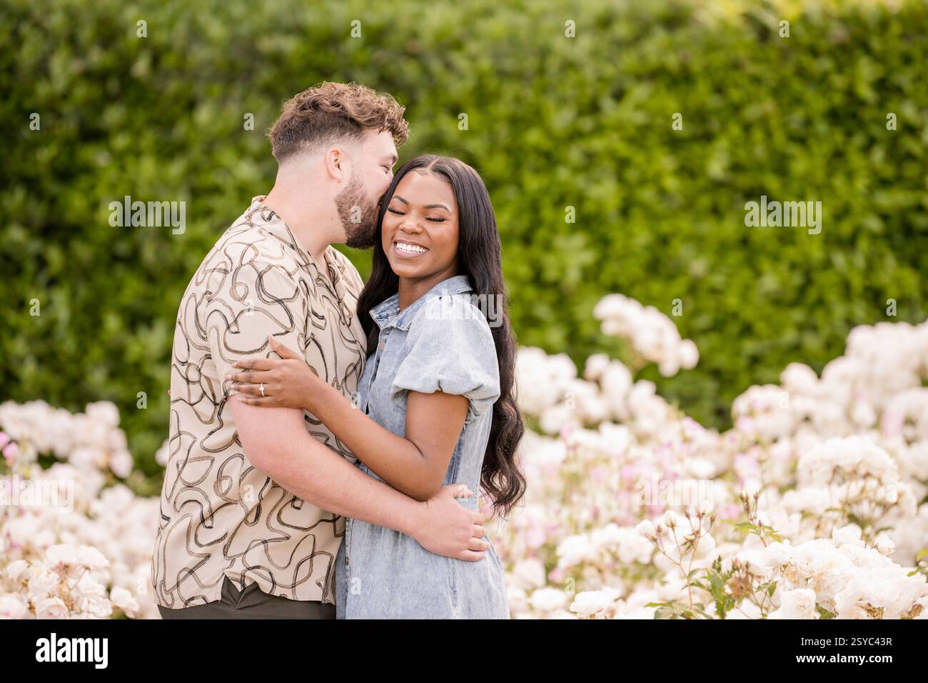 Man giving woman a kiss on her cheek Stock Photo