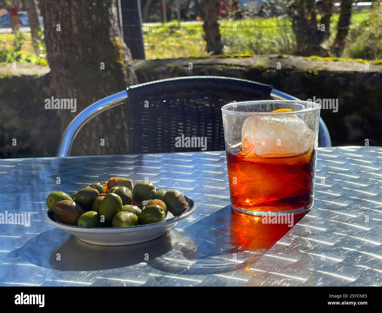 Glass of vermouth with green olives in a terrace. Spain. - Smartphone Captured Stock Image