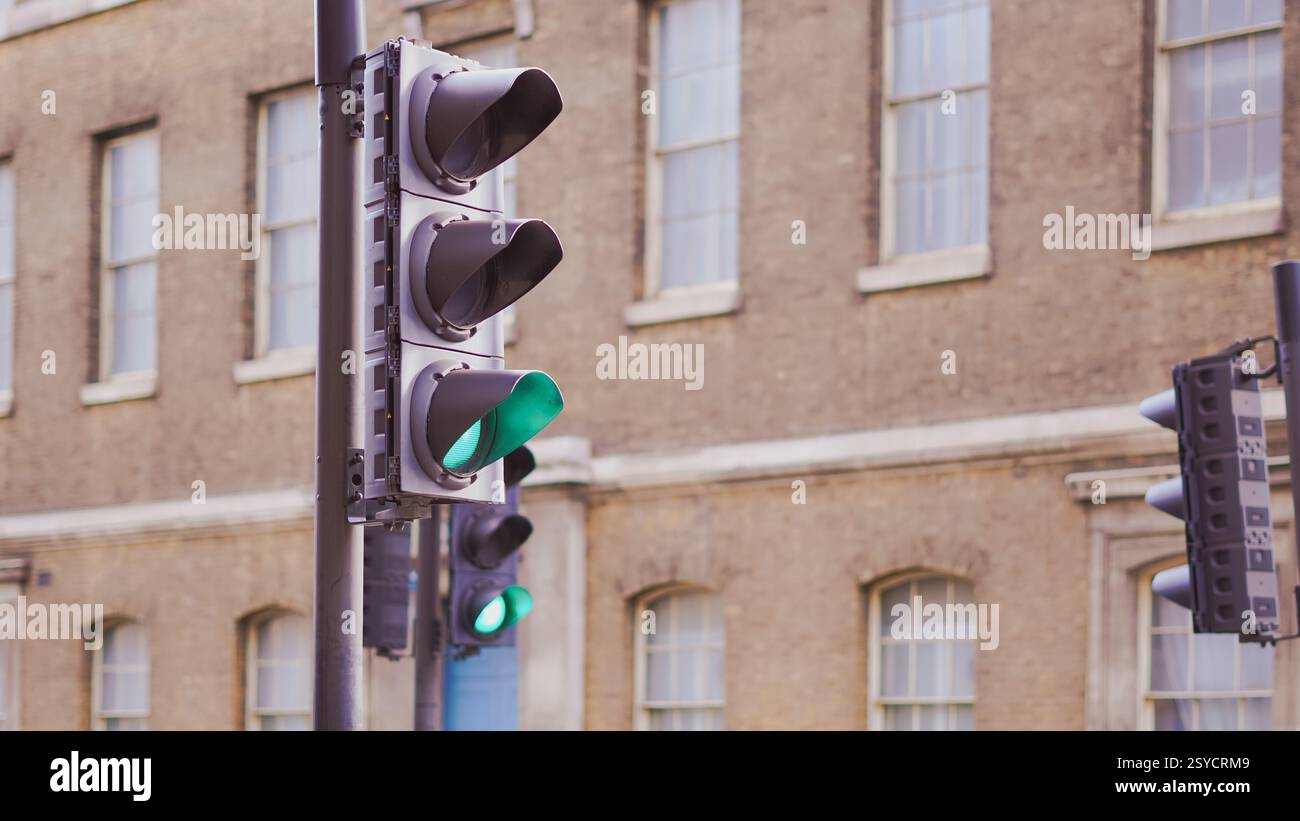 Traffic lights with reflections on wet roads in a modern urban ...