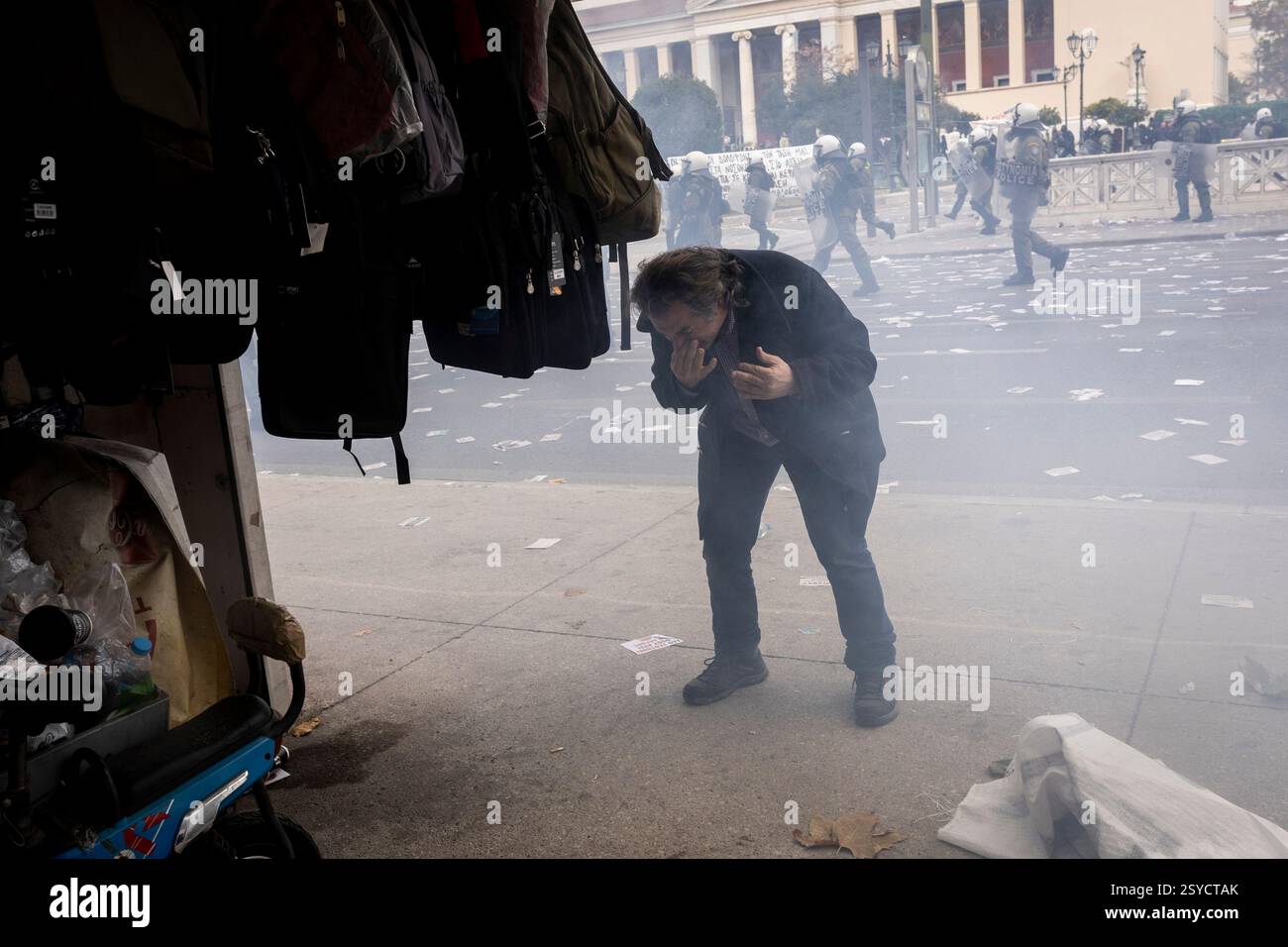Athens Tempi Riots 28 February 2025, Greece, Ath: A person tries to protect himself from ...
