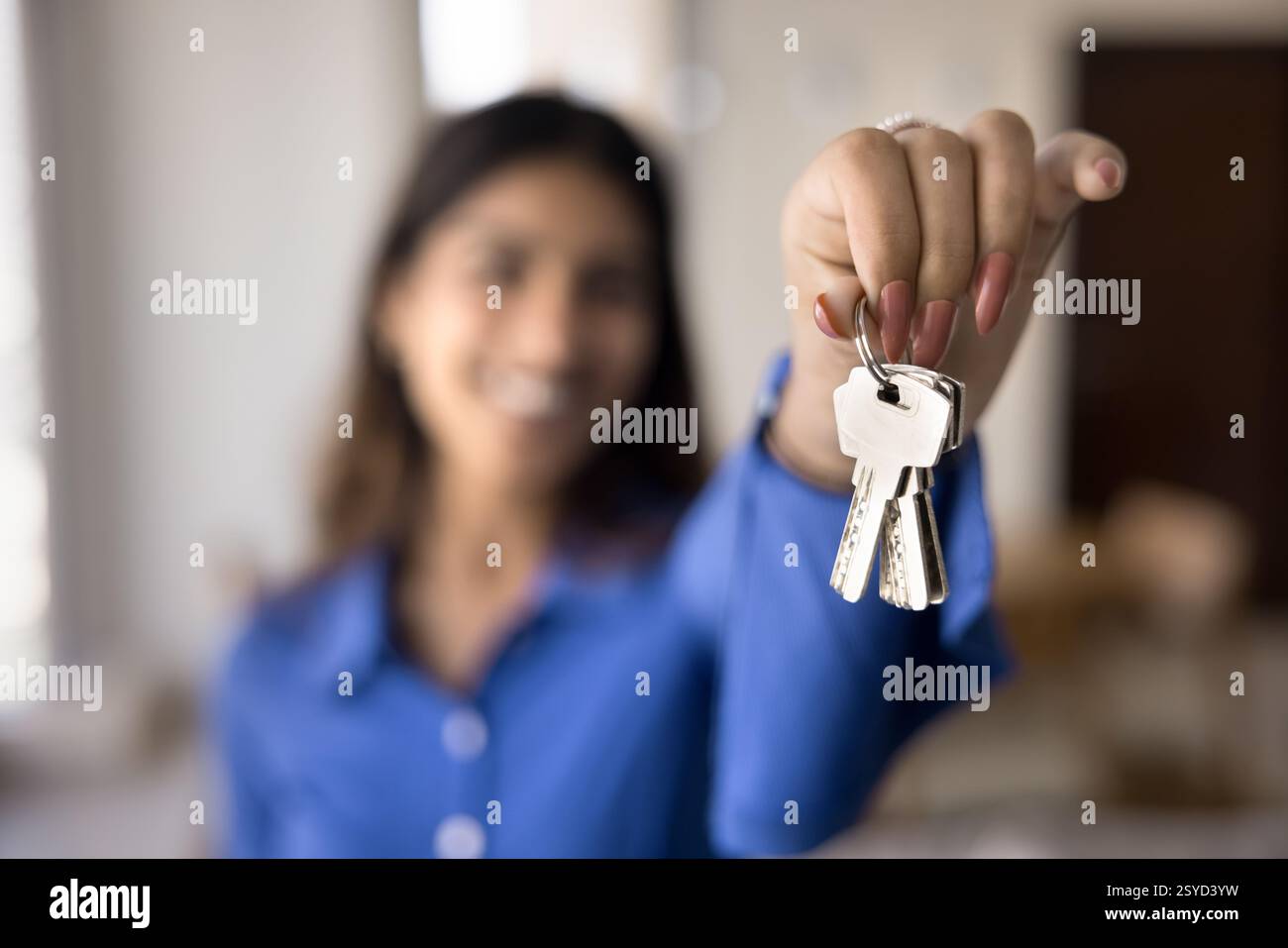Young woman holds keys new hi-res stock photography and images - Alamy