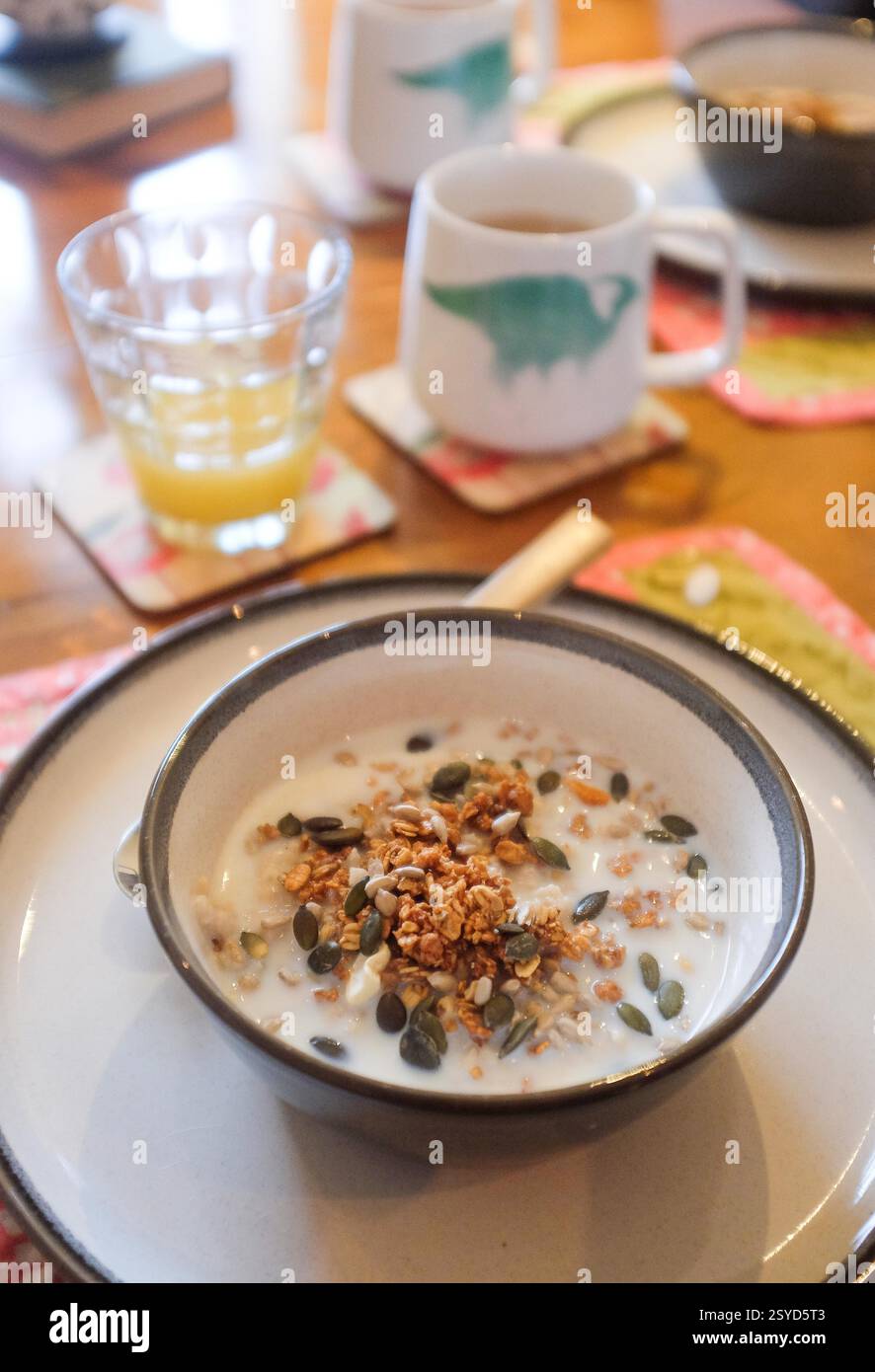 Healthy breakfast of porridge oats with granola and pumpkin seeds on top Stock Photo