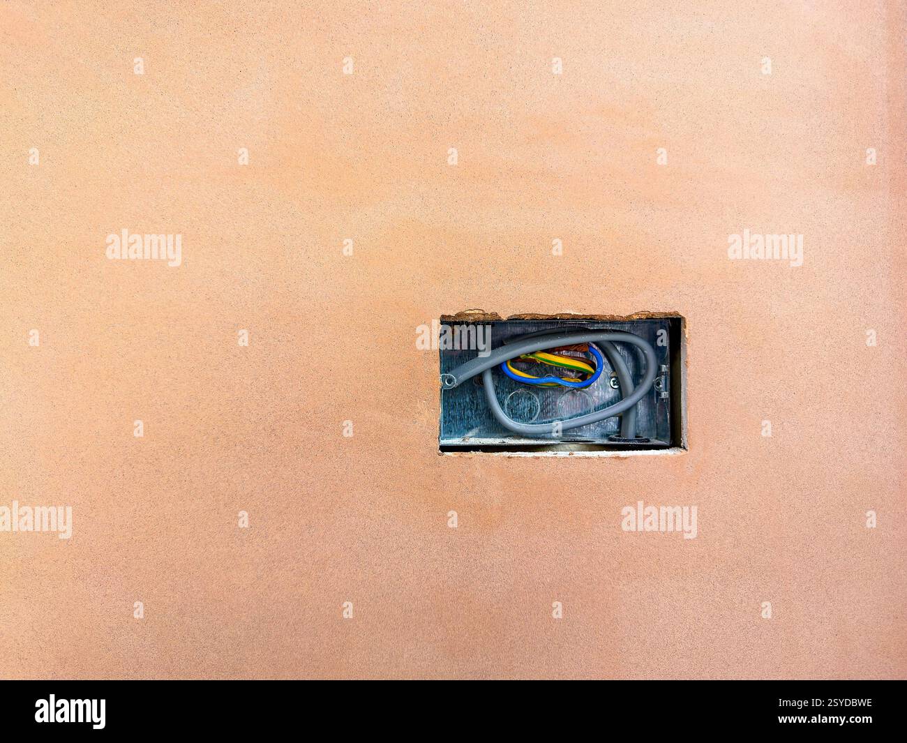 Electric socket in a hole cut in plasterboard on the walls of a house extension. No people. Copy space. - Smartphone Captured Stock Image